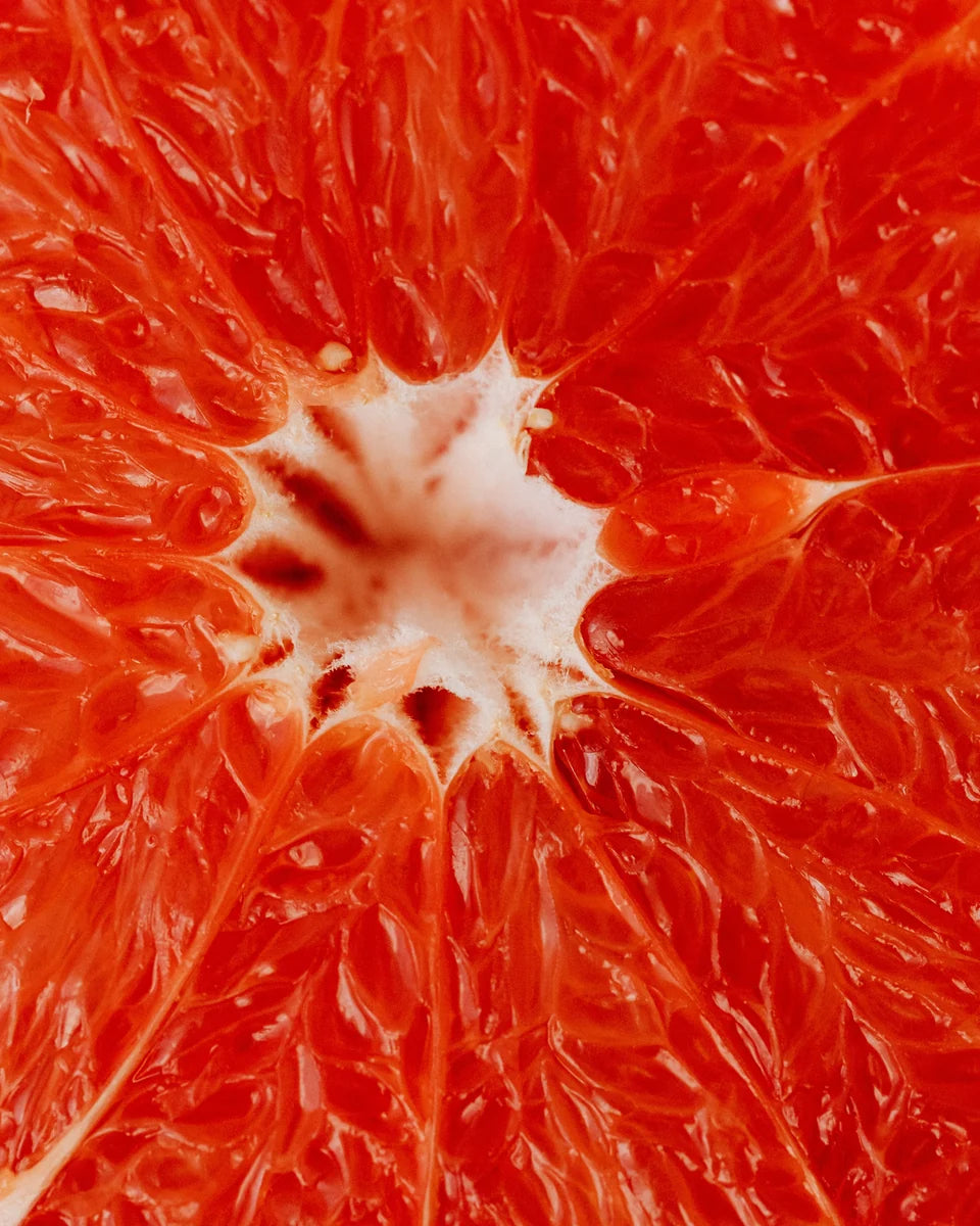Close-up photograph of the segments of a pink grapefruit